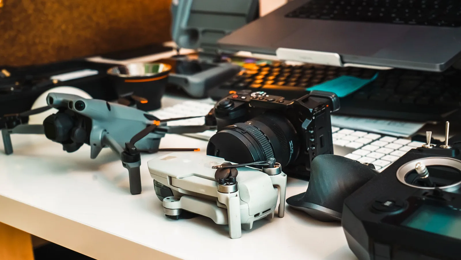 Illustrative equipment selection: drones, camera, controllers and a laptop on a desk